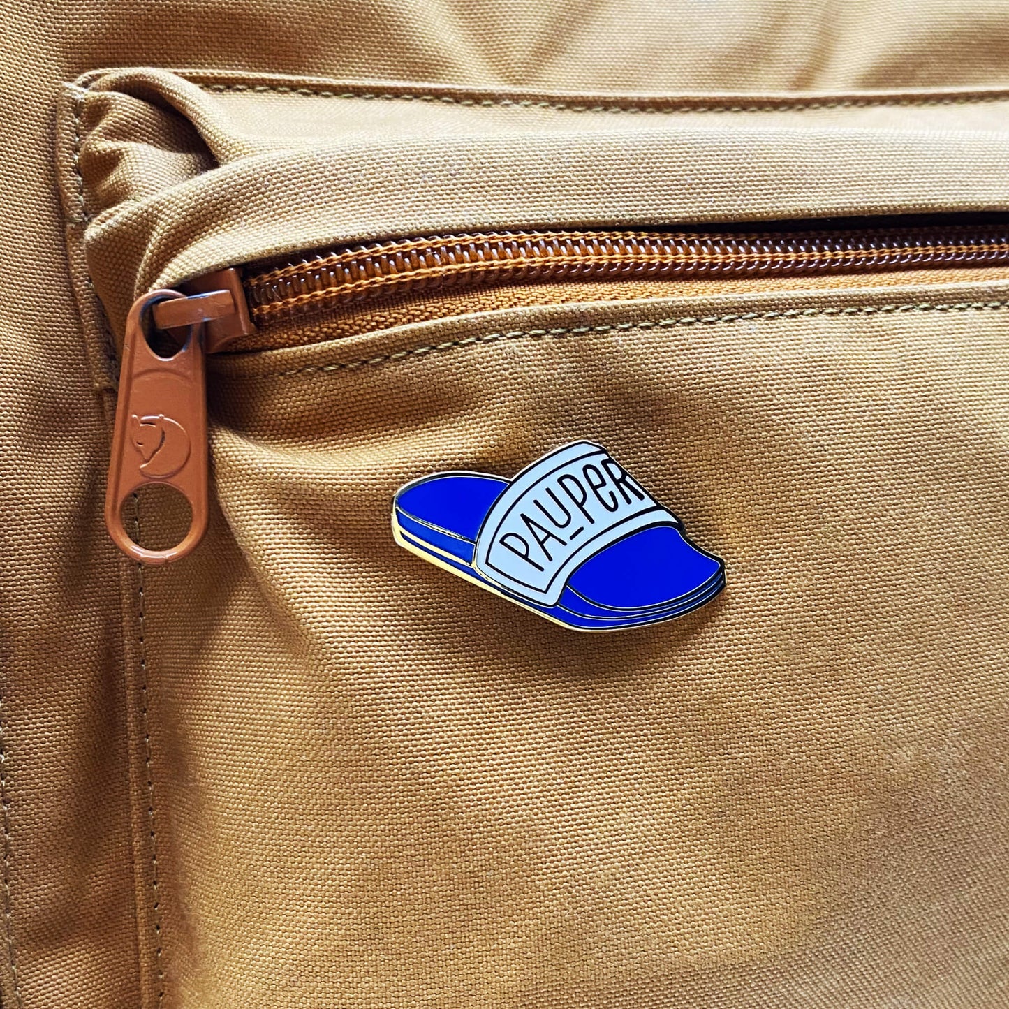 Pauper enamel pin